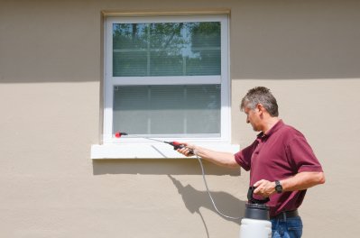 Man spraying termite prevention medicine