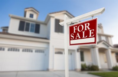 For Sale board in front of the house