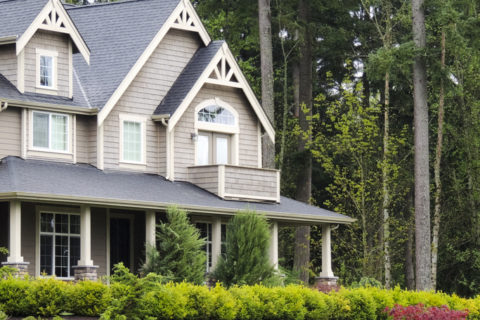 Exterior of a two story home with trees surrounding it