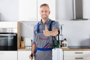 Man standing in kitchen smiling and giving a thumbs up