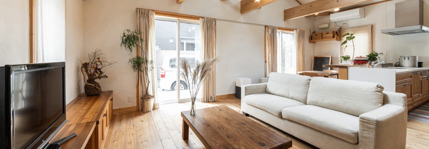 living room in house with exposed wood beams